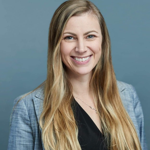 Headshot of a woman with long hair blonde and blue blazer